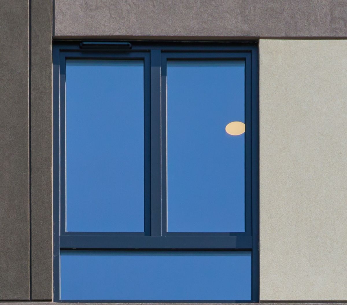 Trickle vent canopies at the heads of the windows on a finished building