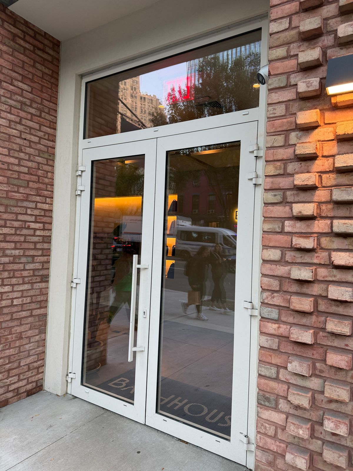 Atlantic: a retail entrance, a pair of doors under a transom, set in the brick