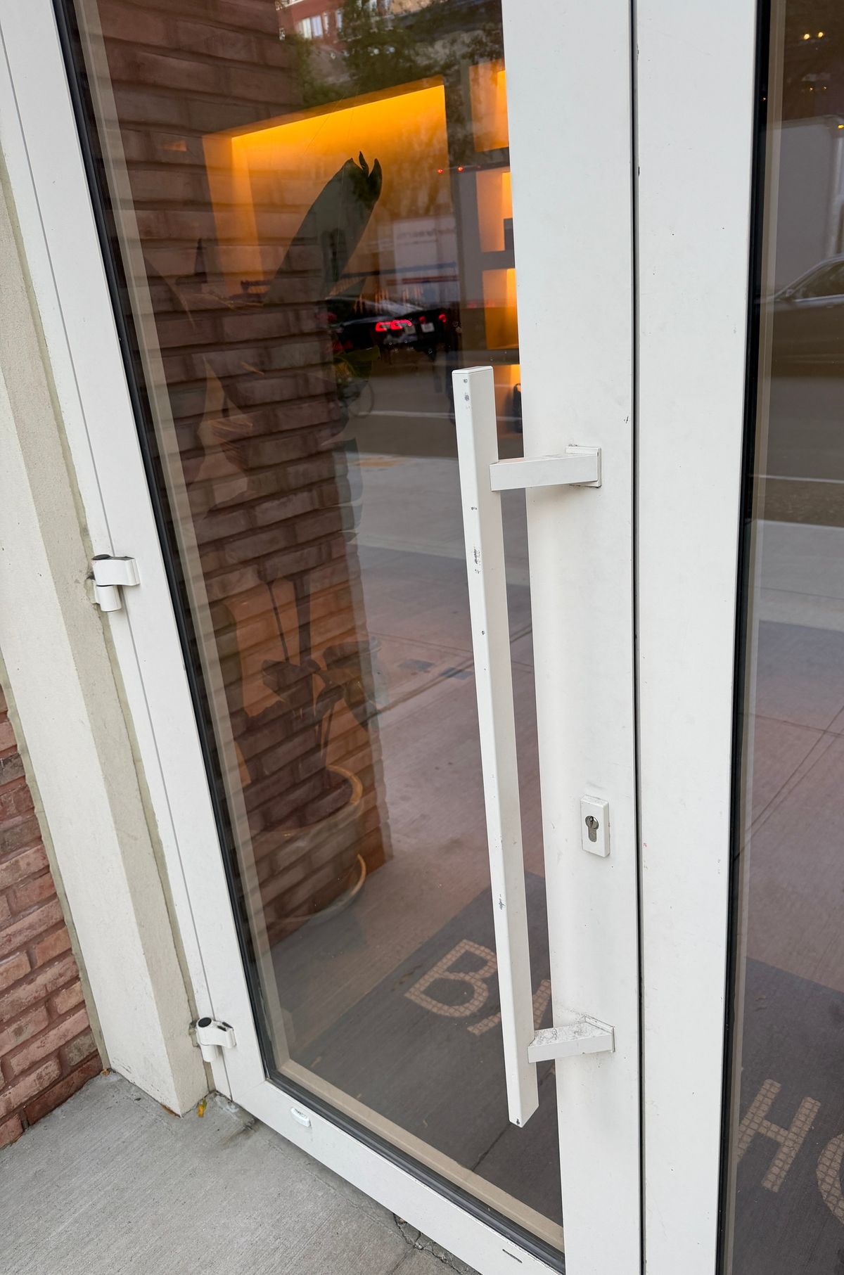 Atlantic: the outside bar pull and lock cylinder on a retail entrance door