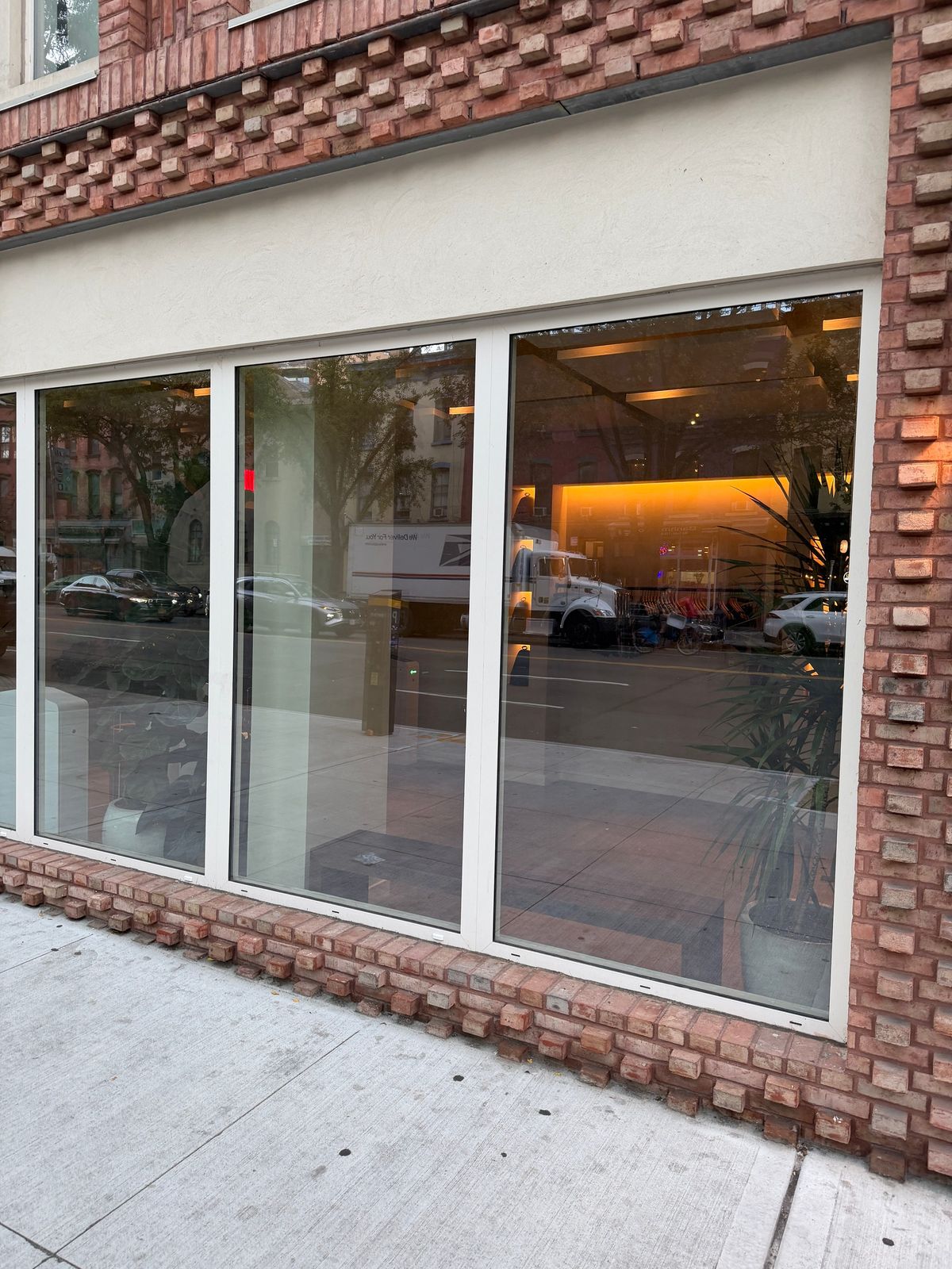 Atlantic: a fixed storefront bay on its brick plinth