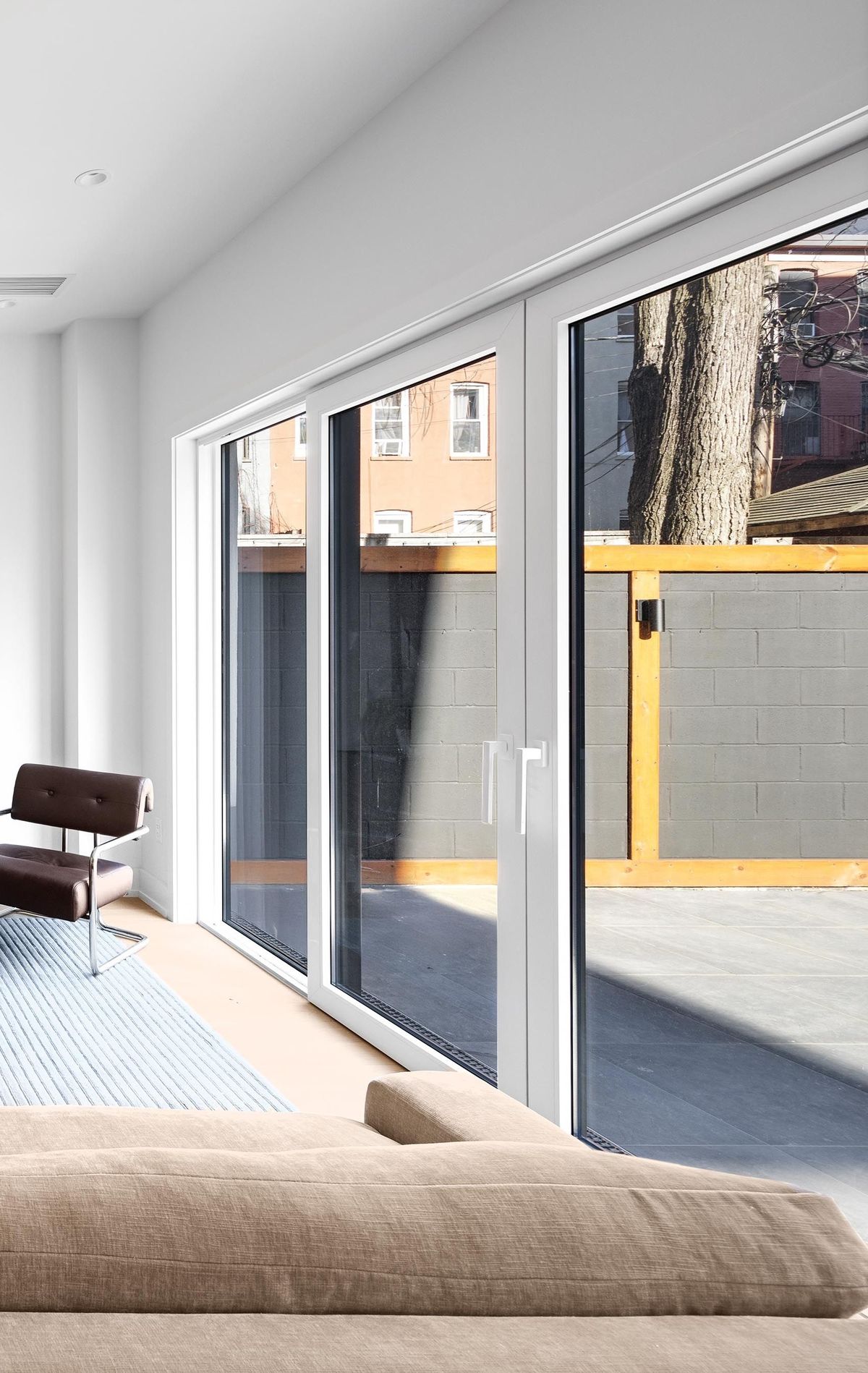 The sliding door seen along its length from inside a furnished room
