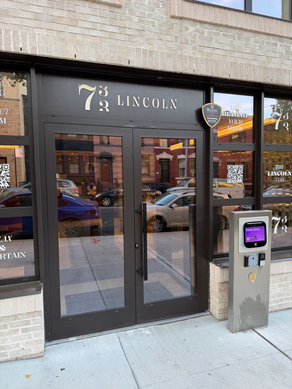 Lincoln Place: the entrance doors and the transom panel with the building's name