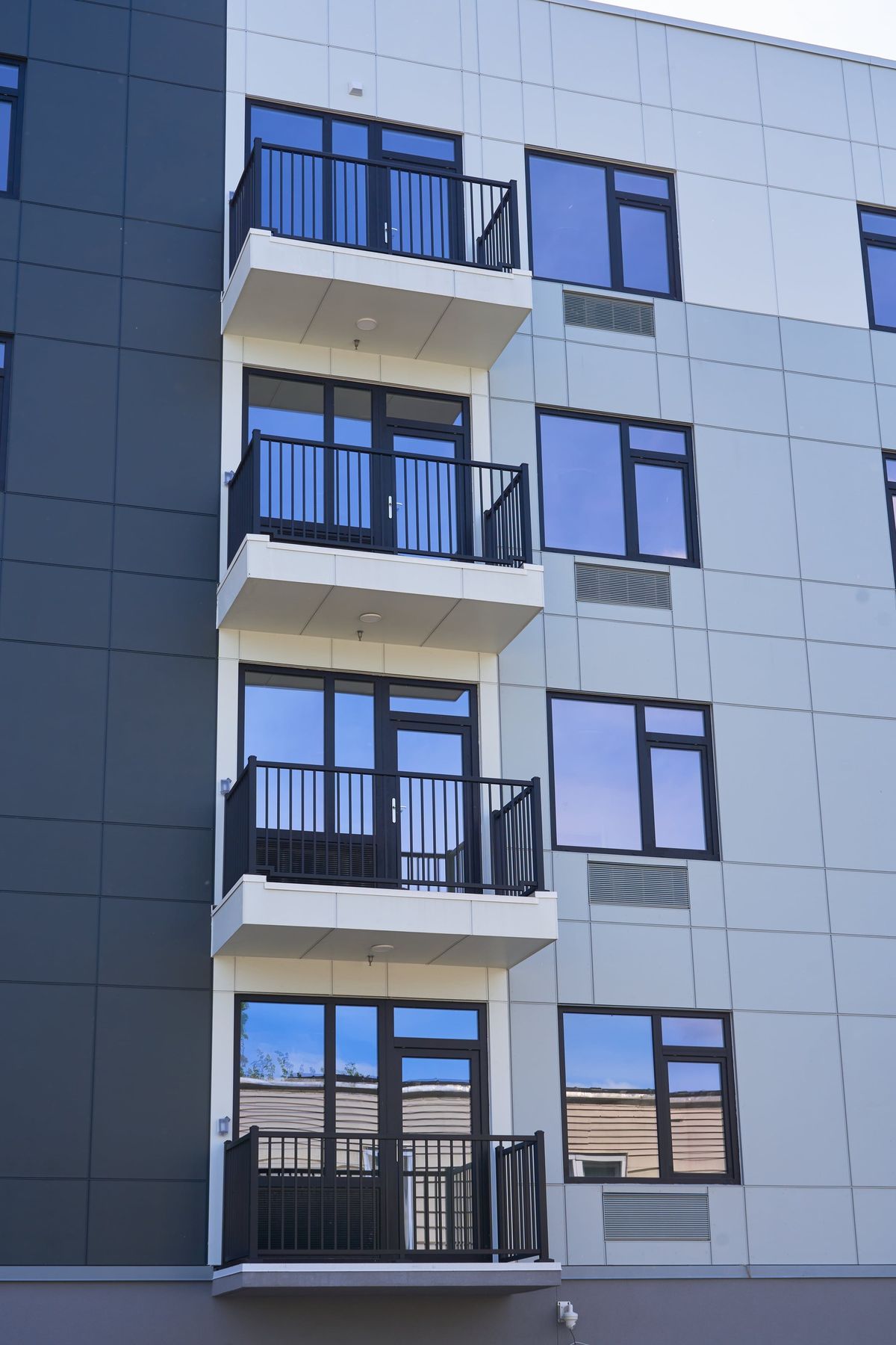 Black windows with louvers under each balcony door