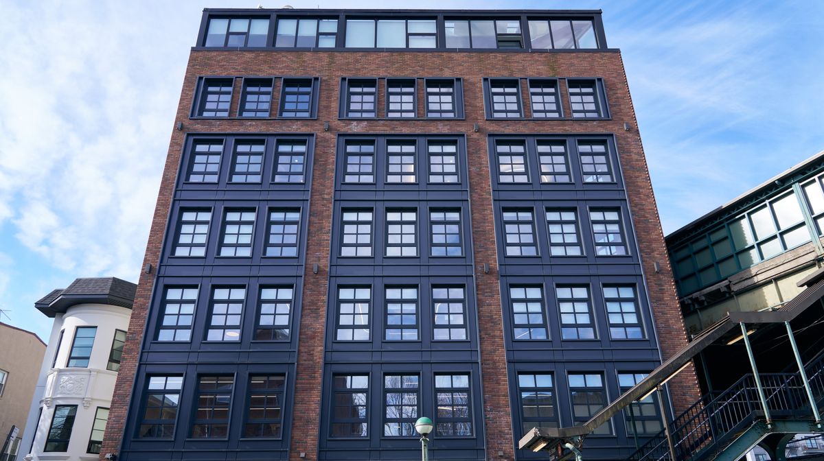 New Utrecht: an eight-story Brooklyn building beside the elevated train, with Charcoal Gray Vi6 windows