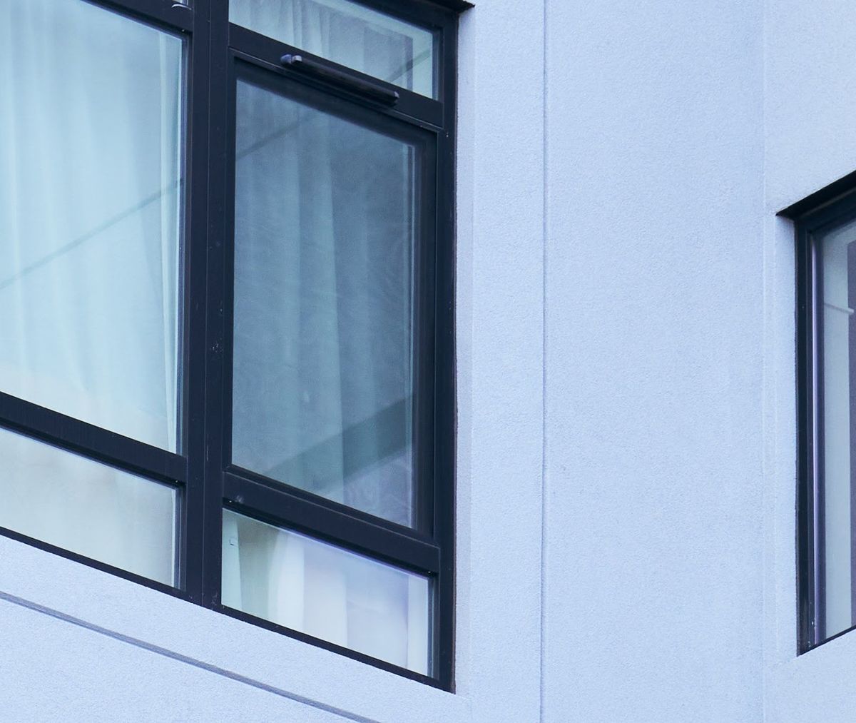 Trickle vent canopies at the heads of the windows on a finished building