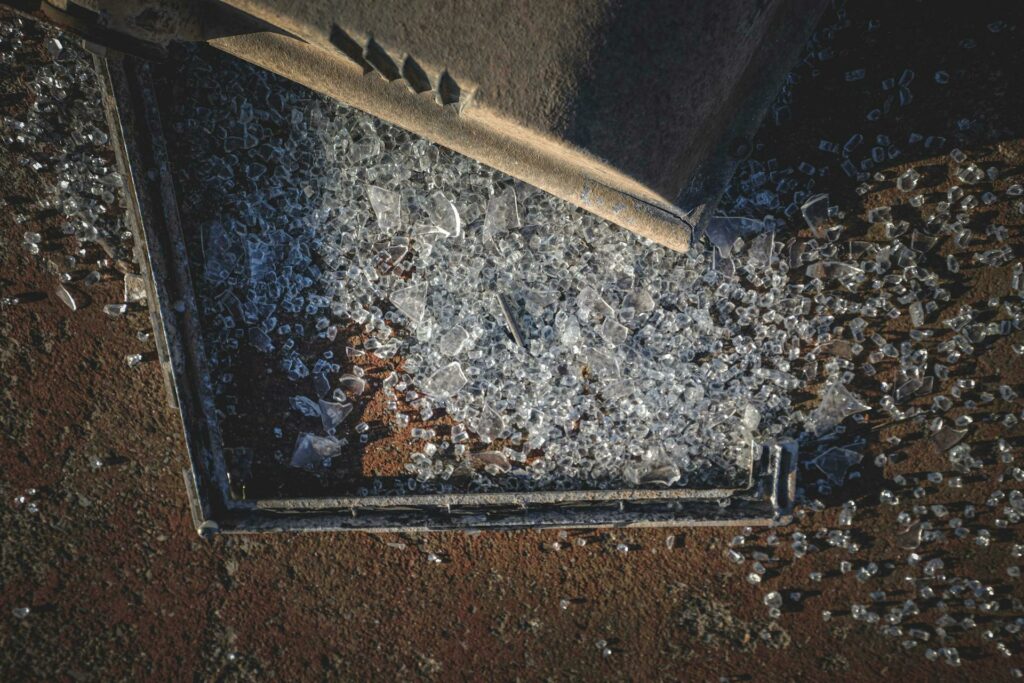 Safety glass shattered on the ground Photo by Pexels.